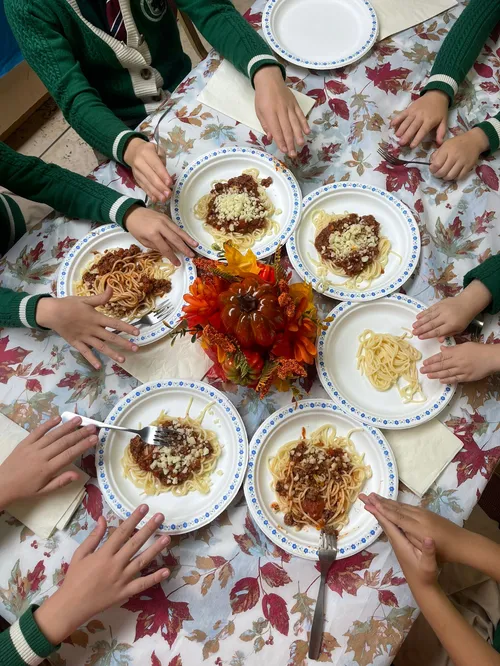 Children enjoying autumn spaghetti lunch at Alderwood Academy