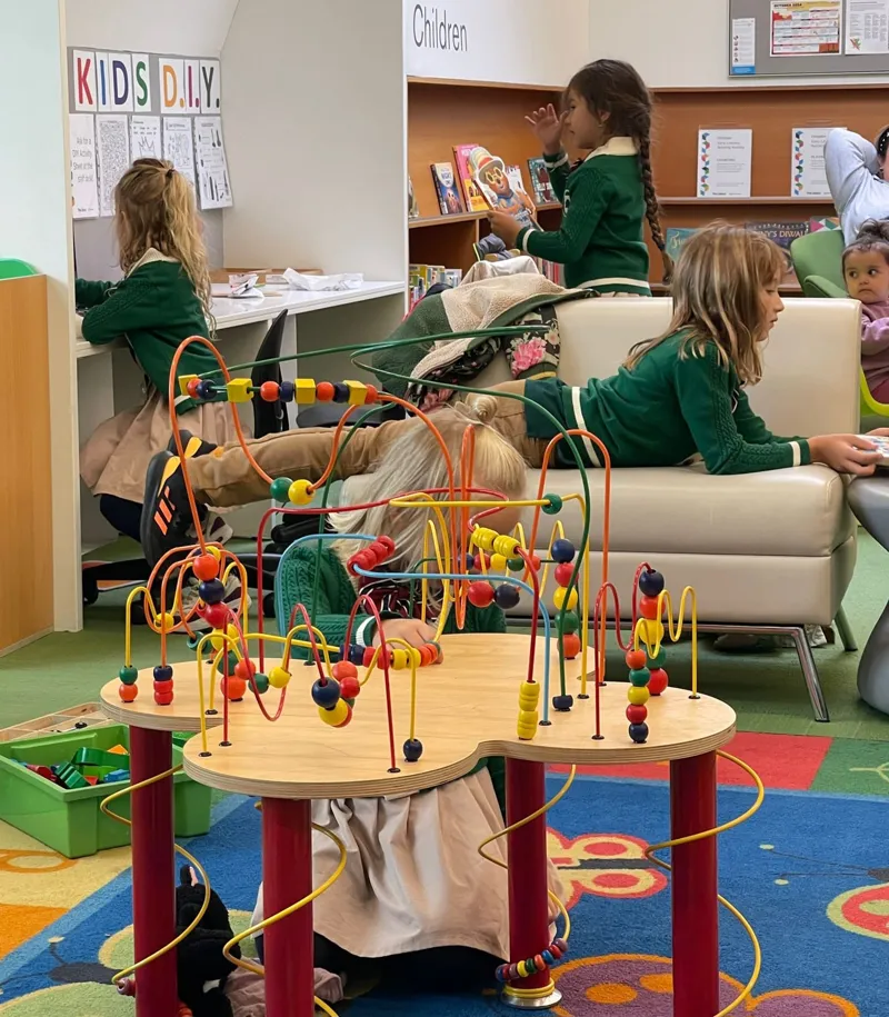 Children engaged in library play learning activities demonstrating innovative child agency at Alderwood Academy