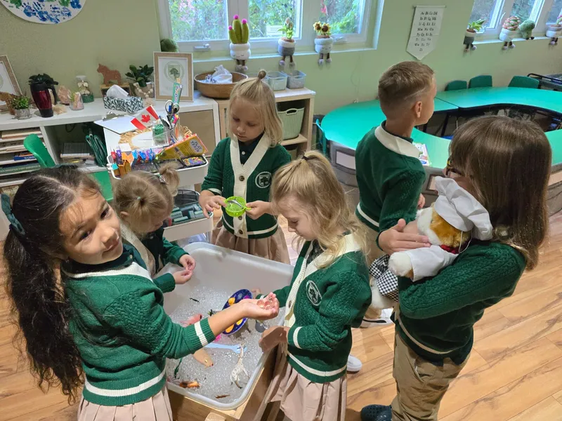 Children exploring sensory bins in classroom demonstrating empowered learning at Alderwood Academy