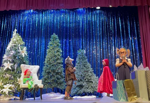Students in winter play costumes performing on stage at Alderwood Academy