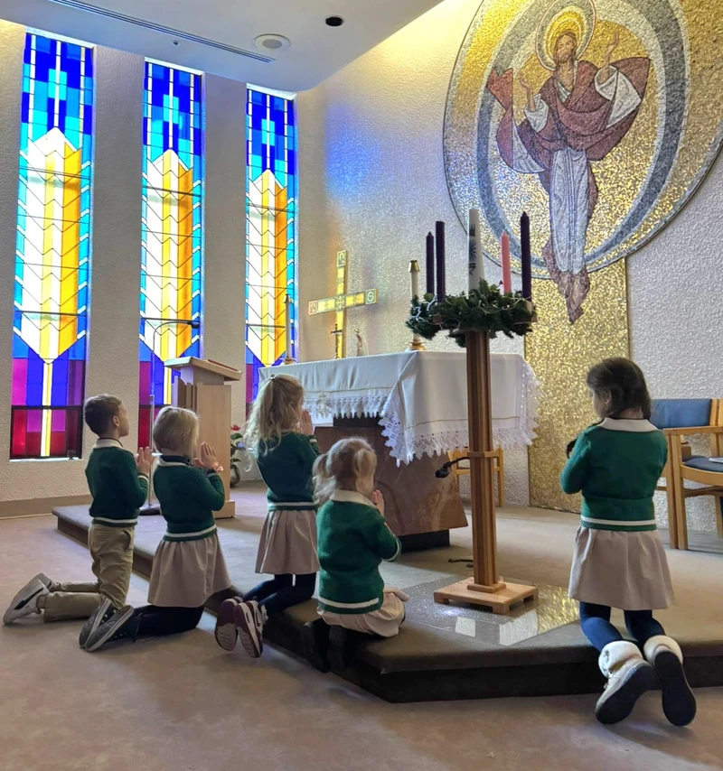 Students engaged in Catholic church prayer demonstrating Catholic values curriculum at Alderwood Academy