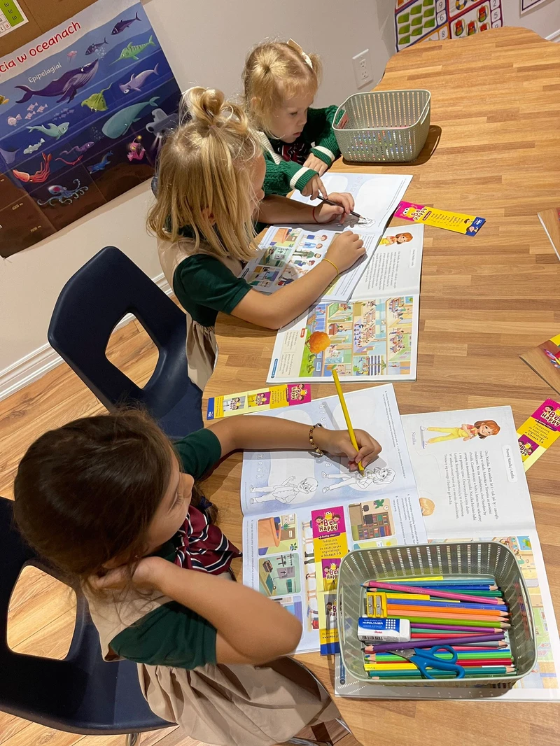 Students engaged in activity books and coloring demonstrating dynamic learning journey at Alderwood Academy